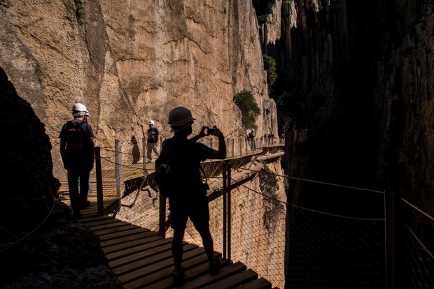 Tourists walk along the 'El Caminito del Rey' (King's Little Path) footpath in Malaga, Spain. 'El Caminito del Rey', ...