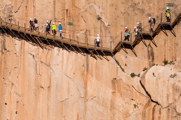 Tourists walk along the 'El Caminito del Rey' (King's Little Path) footpath in Malaga, Spain.