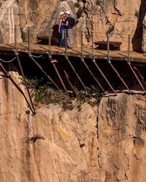 Tourists kiss as they walk along the 'El Caminito del Rey' (King's Little Path) footpath in Malaga, Spain.